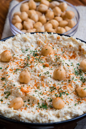 creamy delicious fresh home made hummus in black bowlの写真素材