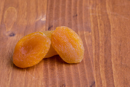 sweet dried orange peach on wooden tableの写真素材