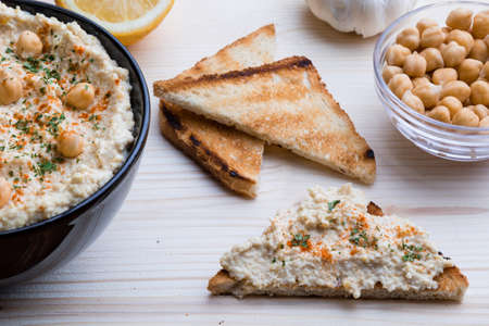 creamy delicious fresh home made hummus with toastの写真素材