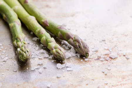 green organic healthy asparagus on steel plate with seasoningの写真素材