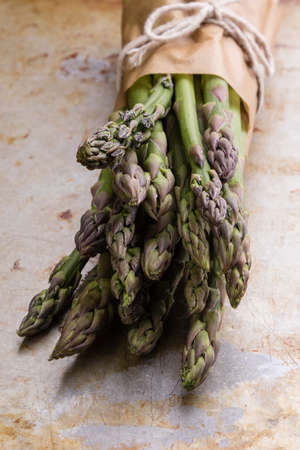 bunch of fresh green organic asparagus on steel plateの写真素材