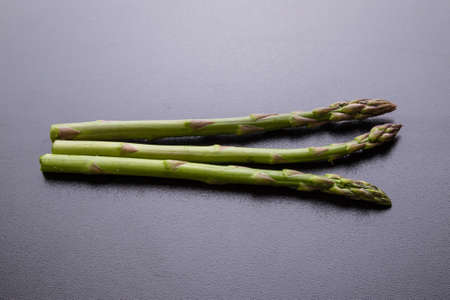 green healthy organic asparagus on black tableの写真素材