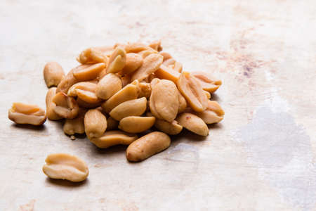 healthy natural brown peanuts on a steel plateの写真素材