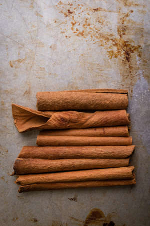 brown healthy cinnamon sticks spice on steel plate