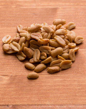 healthy natural brown peanuts on wooden table