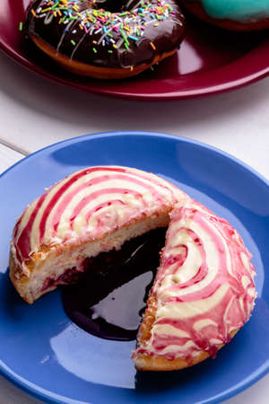donut with spiral frosting on blue plateの写真素材