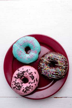 sweet delicious color donuts on red plateの写真素材