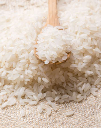 white rice with wooden spoon on tableの写真素材