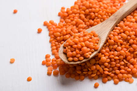 natural organic dry red lentils with spoonの写真素材