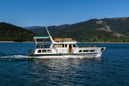 white luxury ship cruising on a lake