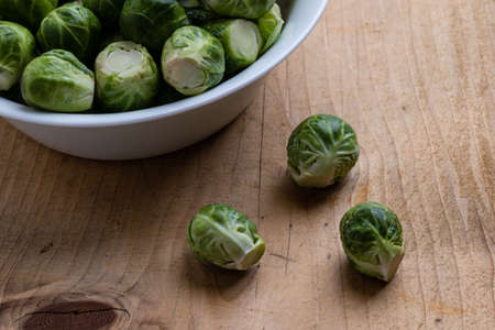 fresh brussels sprouts in white bowl on tableの写真素材