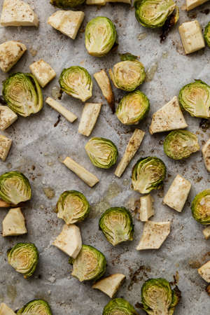 baked green brussels sprouts on baking paper with spiceの写真素材