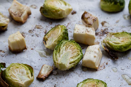 baked green brussels sprouts on baking paper with spiceの写真素材