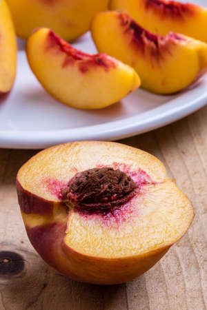 fresh juicy cut peach on wooden tableの写真素材