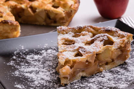 fresh baked apple pie slice on black plateの写真素材