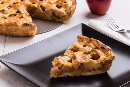 fresh baked apple pie slice on black plate