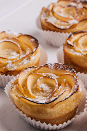 homemade puff pastry with apple shaped roses on white table