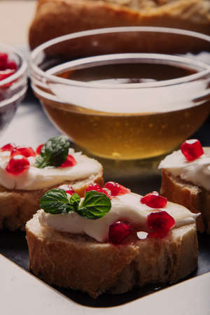 bread with cream cheese pomegranate seeds and honeyの写真素材