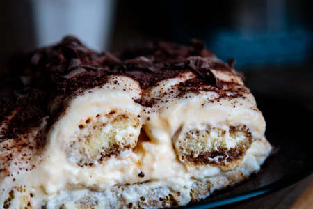 homemade tiramisu dessert on rustic table on black plateの写真素材