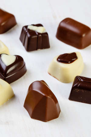 Assortment of delicious chocolate pralines on white tableの写真素材