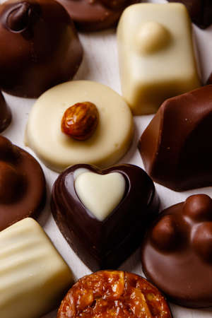 Assortment of delicious chocolate pralines on white tableの写真素材