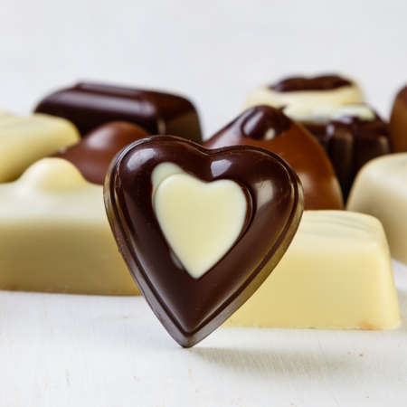 Assortment of delicious chocolate pralines on white tableの写真素材