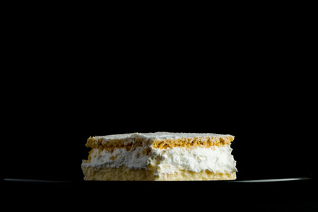 Cream pie with layers of puff pastry on black