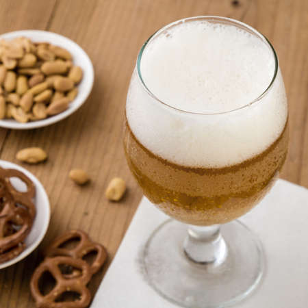 fresh cold glass of beer on wooden tableの写真素材