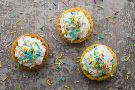 mini tart with whipped cream and color ornamentsの写真素材