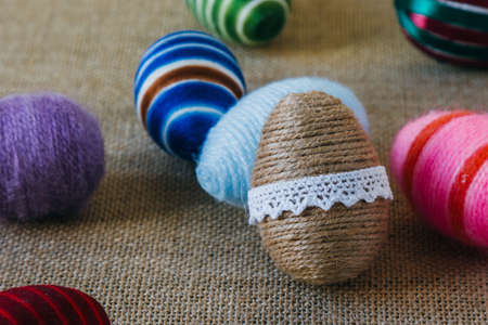 handmade easter eggs wrapped in color stringの写真素材