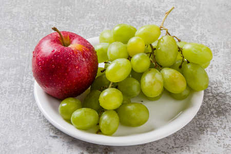 fresh healthy red ripe apple with green grapesの写真素材