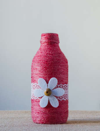 handmade decorated color glass bottle with stringの写真素材