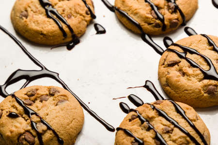 brown chocolate biscuits with syrup on white tableの写真素材