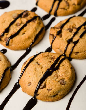 brown chocolate biscuits with syrup on white tableの写真素材