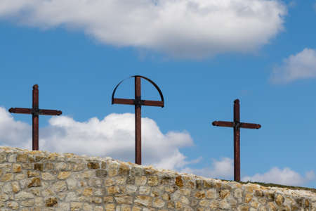 three crosses on hill on blue sky with cloudsの写真素材