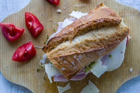 rustic big ham sandwich on wooden boardの写真素材