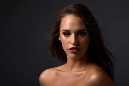 Beautiful woman face close up portrait with professional make up in studioの写真素材