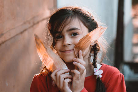 Close-up little girl's face with a smile looking at the cameraの写真素材