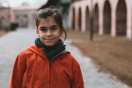 little girl urban portrait with orange teal color gradeの写真素材