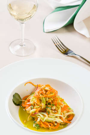 spaghetti from carrots and zucchini with pesto in white plateの写真素材