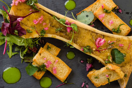 beef bone marrow with chimichurri sauce and french onionの写真素材