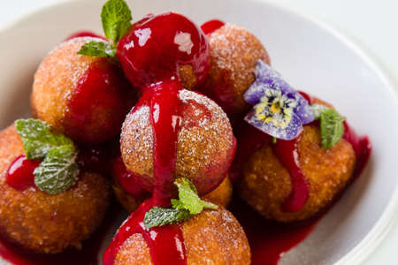 fresh gourmet donut balls desert in white bowlの写真素材