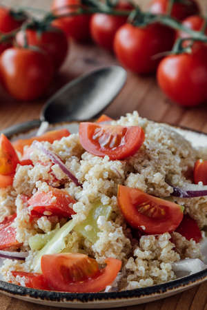 healthy vegetarian quinoa salad with pepper and tomatoesの写真素材