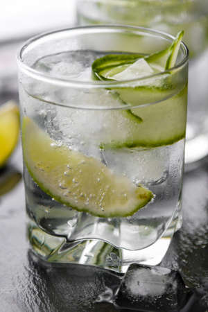 gin tonic with cucumber, lime and ice in glassの写真素材