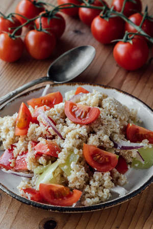 healthy vegetarian quinoa salad with pepper and tomatoesの写真素材
