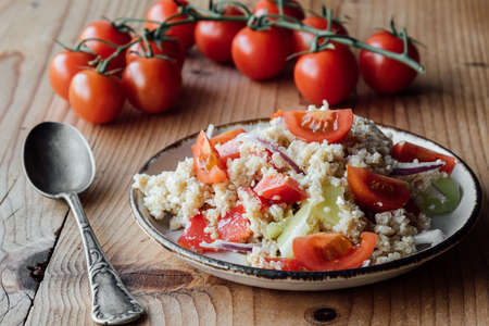 healthy vegetarian quinoa salad with pepper and tomatoesの写真素材