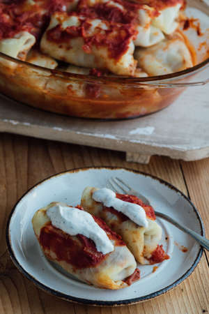 Stuffed cabbage rolls with meat and rice served with tomato sauceの写真素材