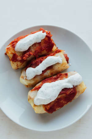 Stuffed cabbage rolls with meat and rice served with tomato sauceの写真素材