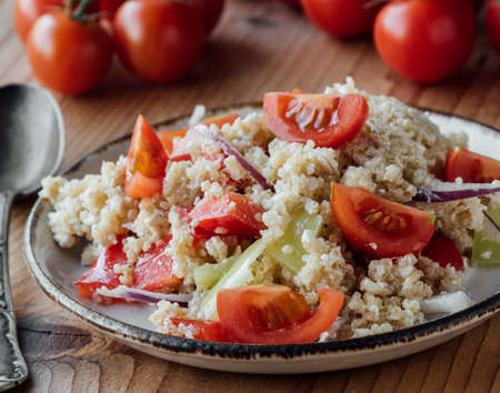healthy vegetarian quinoa salad with pepper and tomatoesの写真素材