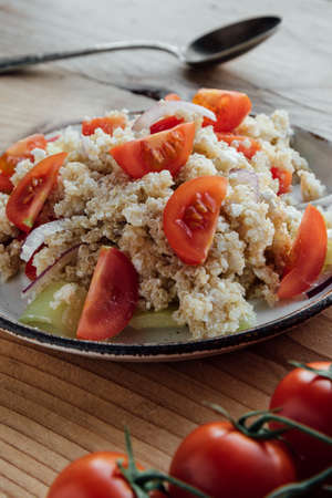 healthy vegetarian quinoa salad with pepper and tomatoesの写真素材